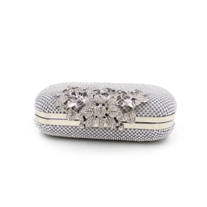 Detailed view of silver crystal evening clutch with leaf pattern and rhinestone finish