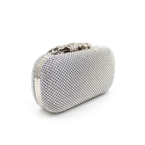 Detailed view of silver crystal clutch with ornate leaf and flower rhinestone clasp