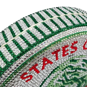 Close-up of football-shaped evening clutch bag with green and red rhinestones
