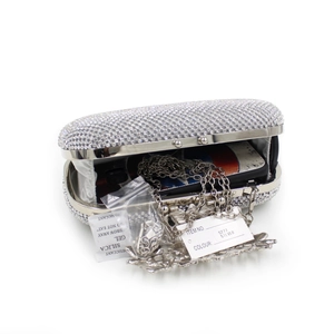 Detail of silver rhinestone evening clutch with crystal leaf pattern and chain strap