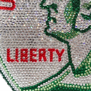 Macro detail of red rhinestones forming LIBERTY on a crystal-encrusted evening bag