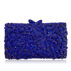 Macro detail of royal blue crystal evening clutch with floral rhinestone pattern and bow clasp
