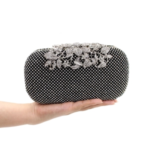 Detailed macro of a luxury black evening clutch with sparkling leaf crystal embellishments