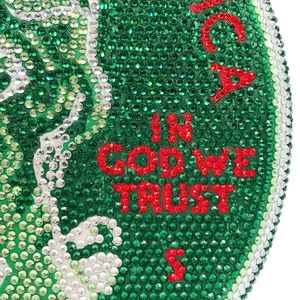 Macro detail of dollar bill pattern clutch bag with emerald rhinestones and crystal studs