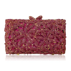 Macro detail of rose red rhinestone evening clutch with 3D flower pattern and butterfly clasp