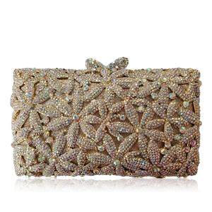 Golden luxury crystal evening clutch bag with floral rhinestone hollow pattern and bow clasp