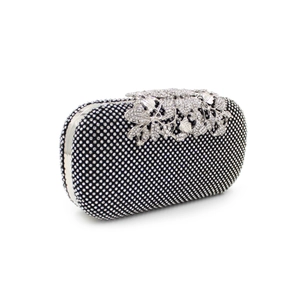 Detailed close-up of crystal leaf design on black luxury evening clutch with silver accents