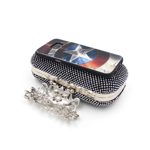 Detailed close-up of sparkling rhinestone evening clutch bag with ornate floral clasp