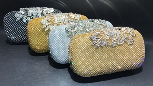 Macro shot of rhinestone evening clutches with ornate metal leaf and flower decorations