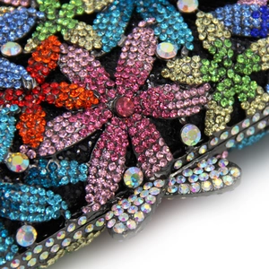 Macro detail of multicolored crystal rhinestones in floral patterns on evening clutch bag