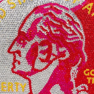 Close-up of Liberty coin design on evening bag with red and gold rhinestones
