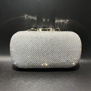 Detailed view of silver crystal rhinestones on a rectangle evening clutch bag