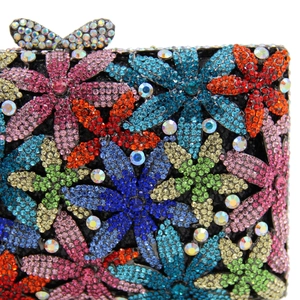 Detailed close-up of colorful crystal floral patterns and butterfly clasp on evening clutch