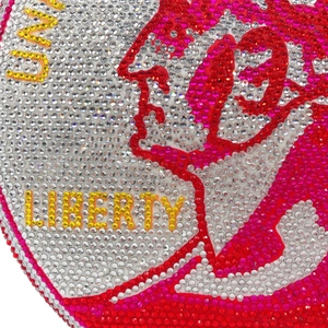 Macro shot of sparkling rhinestones spelling LIBERTY and US on a luxury evening clutch