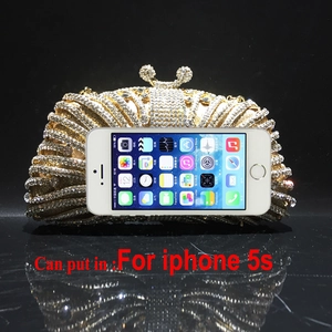 Detailed view of luxury gold evening clutch bag with rhinestones and decorative handle
