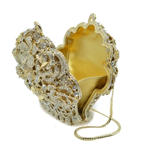 Macro view of gold evening bag with luxury crystal floral pattern and chain strap
