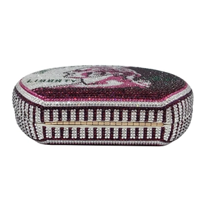 Macro view of ALMIGHTY text design on a luxury rhinestone encrusted round clutch bag
