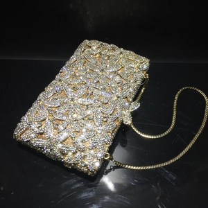 Detailed close-up of intricate gold floral crystal pattern on rectangular clutch bag
