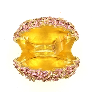 Detail of pink crystal evening clutch bag with golden lining and sparkling rhinestones