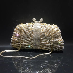 Luxurious gold evening clutch bag with sparkling white rhinestones and a metal chain