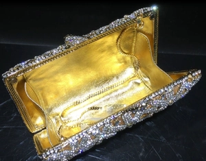 Detailed macro view of luxury crystal evening clutch with champagne rhinestones and chain