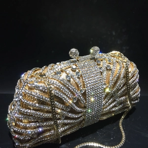 Luxurious gold evening clutch bag with sparkling crystals and metal chain strap