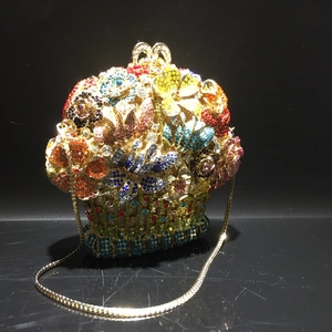 Detail of multi-color crystal flower evening clutch with gold metal chain and floral pattern