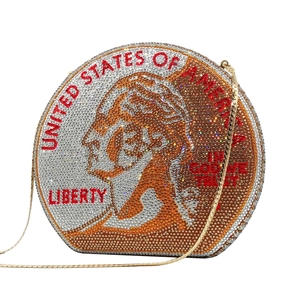 Detailed view of round penny evening bag with shimmering rhinestones and a gold chain strap