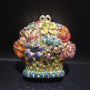 Exquisite flower basket evening clutch featuring multi-colored crystals and metal handle