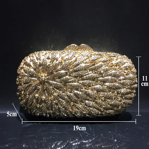 Detail view of a luxury gold rhinestone clutch bag showing dimensions 19cm by 11cm