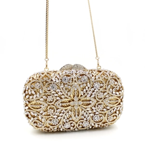 Close-up of hollow metal hollow frame and rhinestones on gold evening clutch bag