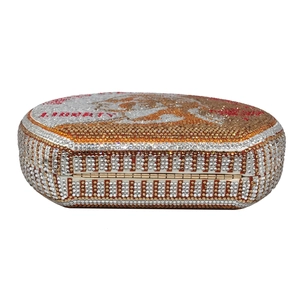 Detailed close-up of crystal-embellished liberty dollar evening clutch with gold rhinestones