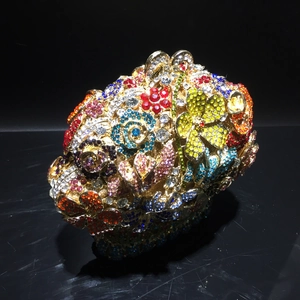 Detailed macro view of vibrant colorful crystals and floral rhinestones on luxury clutch