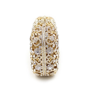 Side view of hollow golden evening clutch with rhinestones and floral metalwork