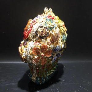 Macro detail of poodle shaped crystal evening bag with luxury gold finish and colorful rhinestones