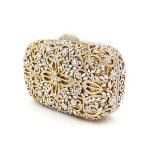 Close-up of golden hollow evening clutch with intricate floral patterns and crystals