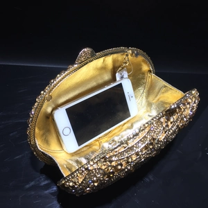 Internal capacity of gold rhinestone clutch showing space for a smartphone
