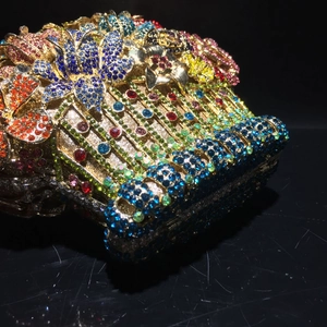 Macro shot of luxury hollow metal evening clutch with multi-color floral crystal rhinestones