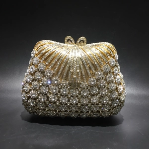 Luxury gold crystal evening clutch with sparkling rhinestones and a bow clasp