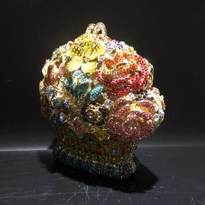 Detailed view of luxury flower basket evening bag with colorful crystals and gold ring handle