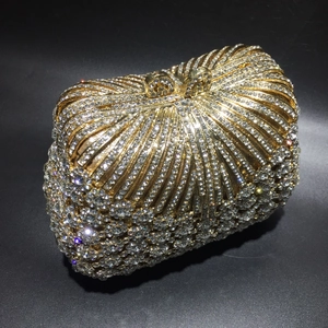 Golden luxury metal clutch bag with handcrafted sparkling crystals for formal evening events