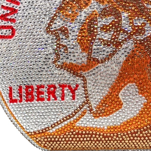 Macro detail of Liberty crystal rhinestone evening bag with sparkling red and orange gems