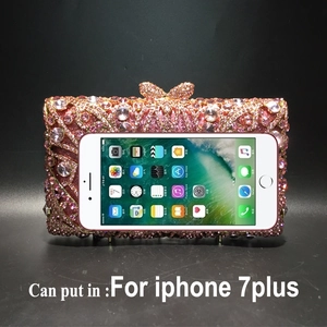 Detail showing inner capacity of rhinestone evening bag with smartphone for size reference