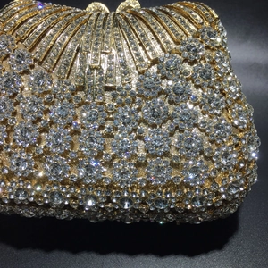 Luxury gold evening clutch bag with sparkling crystals and radial hollow metal design