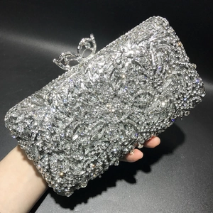 Detail of silver rhinestone evening clutch with a luxury bow metal clasp closure