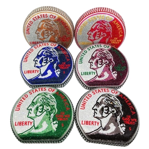Detail view of colorful dollar coin evening bags featuring sparkling rhinestones