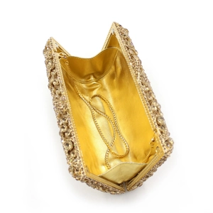 Close-up of gold rhinestone evening clutch with crystal inlay and metal chain strap