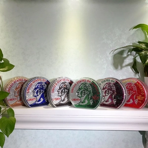 Detail of colorful round dollar-shaped clutch bags with rhinestone liberty coin patterns