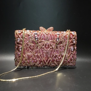 Pink rhinestone evening clutch bag with crystal bow clasp and gold chain strap