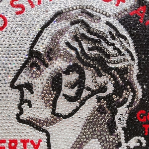 Detailed macro view of the Liberty coin design made of sparkling rhinestones on the bag